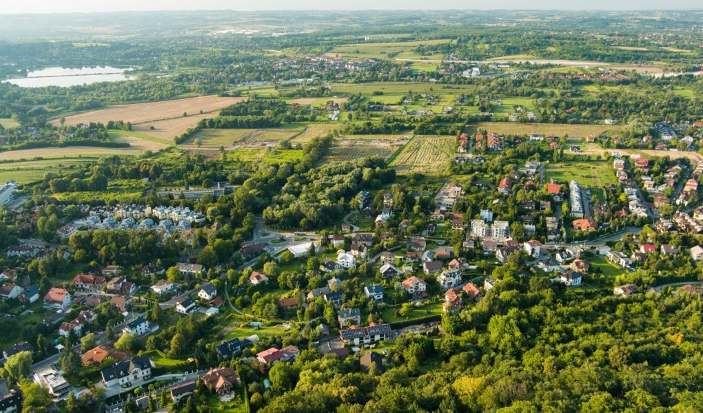 Piękny widok z góry na przedmieścia z ładnymi domami i samochodami w słoneczny letni dzień w Krakowie, Polska.