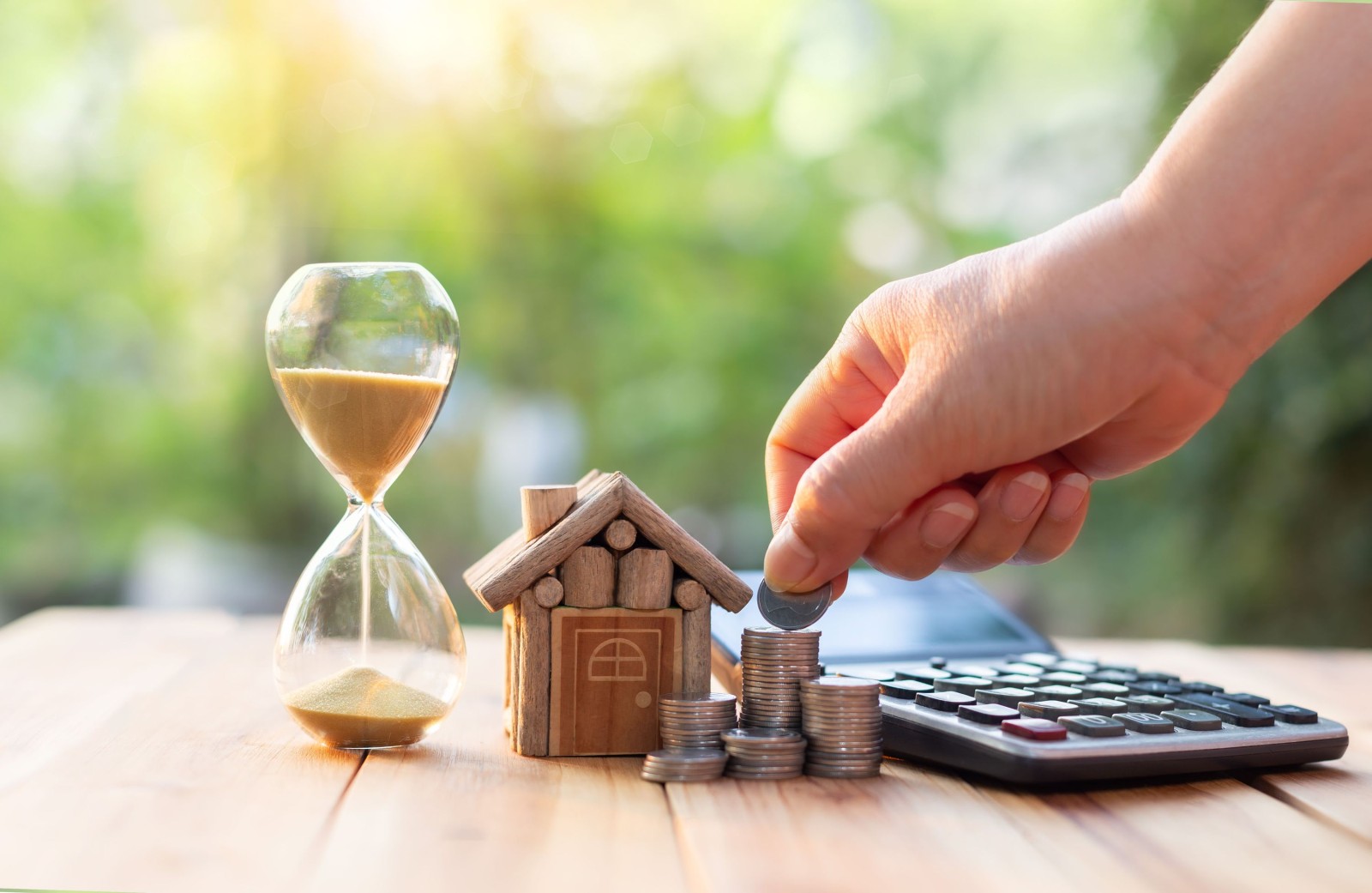 Ręka wkładająca monety do rzędu monet. Nieruchomości lub rozwoju nieruchomości. Plan oszczędzania monet na zakup domu pomysły na nieruchomości hipoteczne i inwestycje w nieruchomości na zakup domu.