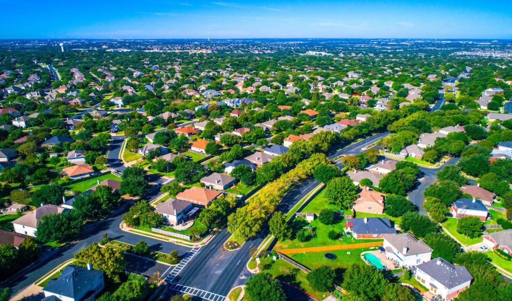 Setki domów wzdłuż zakrzywionych nowoczesnych dróg nowego przedmieścia na północ od Austin w Round Rock, Teksas, USA widok z lotu ptaka nad przedmieściem suburbia społeczność sąsiedzka